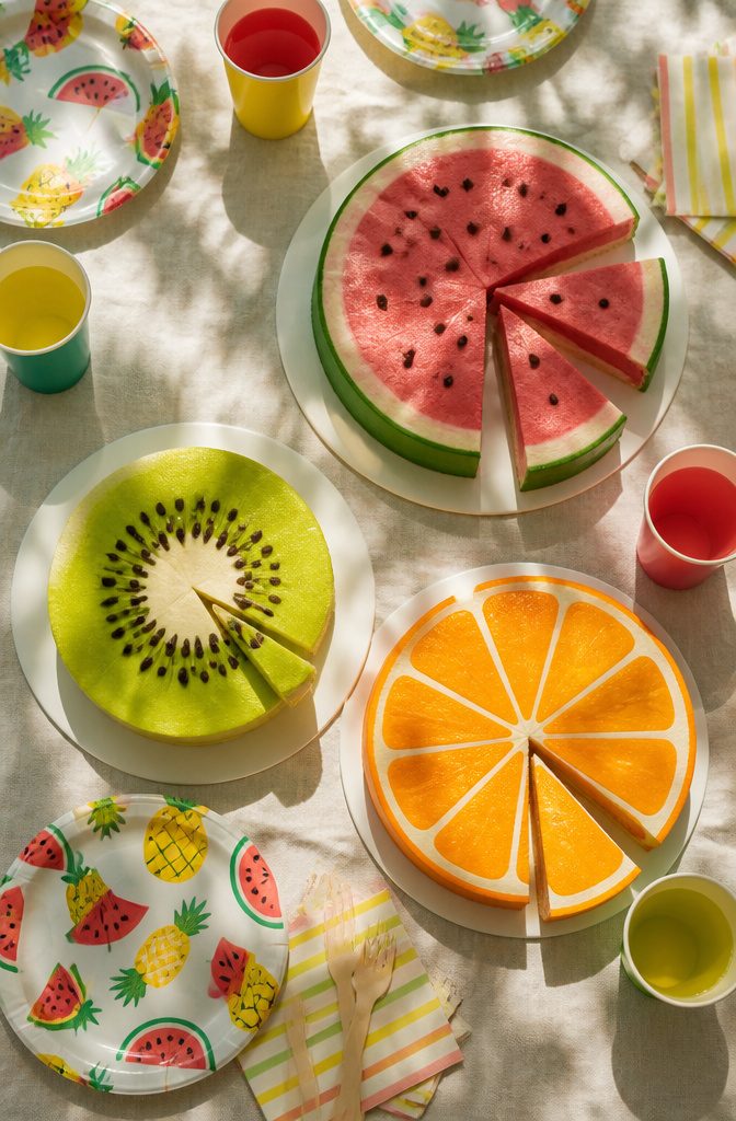 A cake designed as a watermelon slice, with chocolate chip 'seeds.'