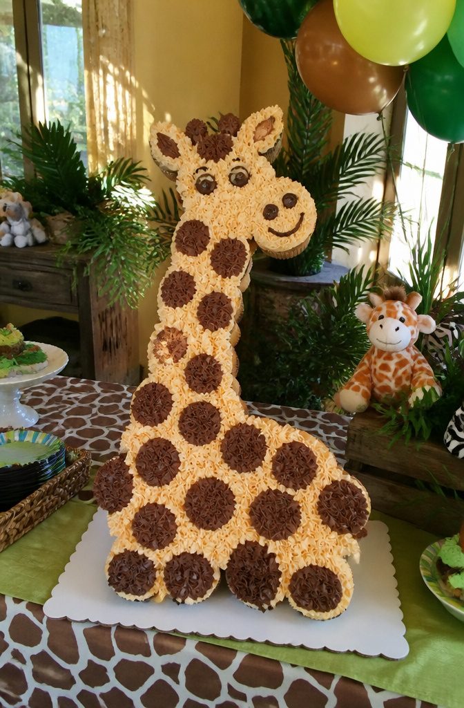 Cupcakes arranged to form a giraffe with tan frosting and brown spots.