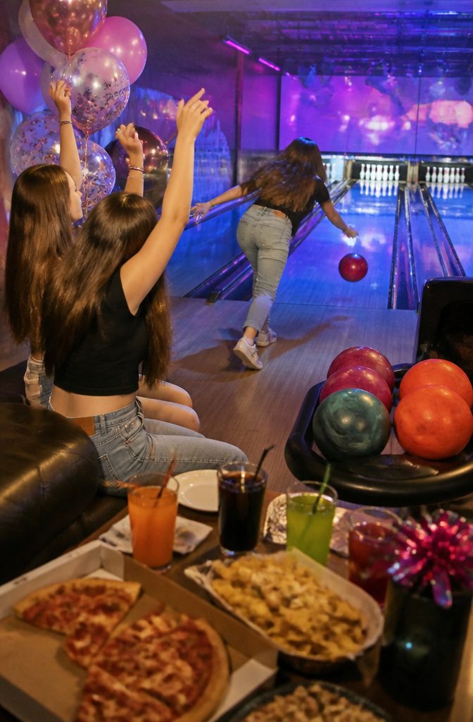 16 Sweet Sixteen Birthday Party Ideas for an Unforgettable Celebration 12 Guests bowling and celebrating in a vibrant bowling alley atmosphere.